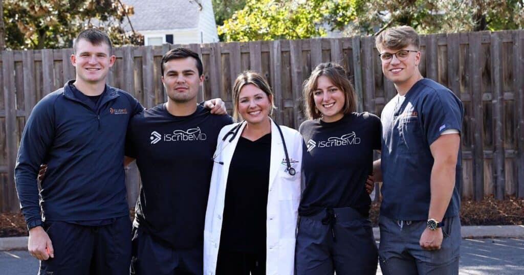 A group of medical scribes from iScribeMD with a doctor.